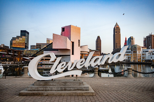 In Ohio the Cleveland script sign is placed in front of the cityscape with the Rock and Roll Hall of Fame building.