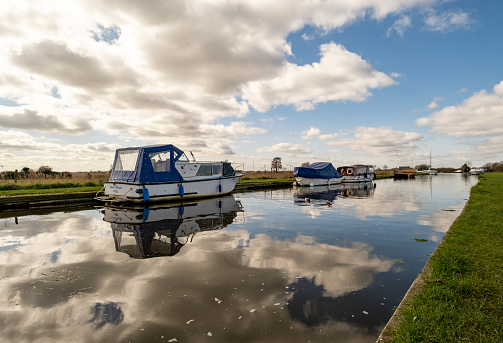 Thurne, Norfolk, UK  March 16 2023. Motor boats and leisure boats moored in the dyke in the Norfolk countryside