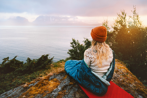 Woman enjoying view with bivouac gear travel vacations girl hiking solo in mountains camping outdoor active tourist exploring Norway adventure healthy lifestyle summer trip sustainable tourism