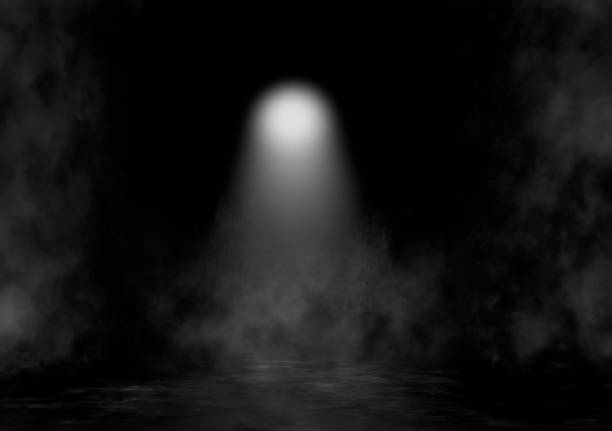 istock A spotlight of light coming from above in a smoky environment 2104890554