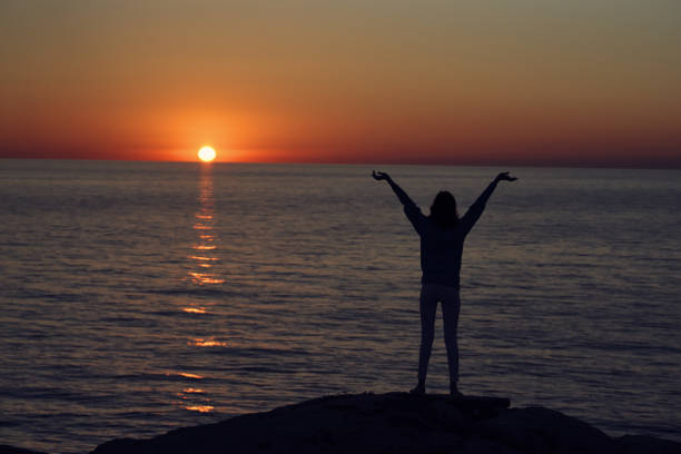 istock Beach mountains landscape sun sunset female silhouette 2104902157