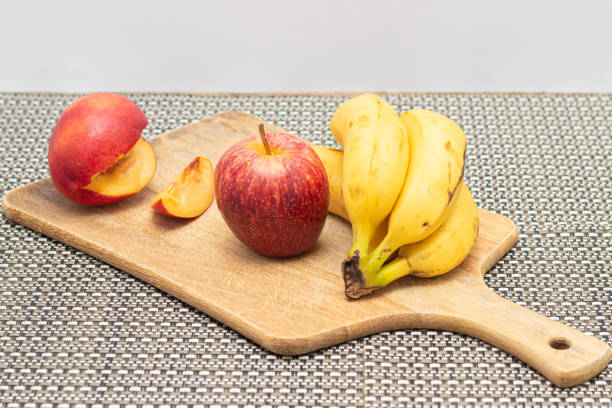 View of cut fruit in a kitchen on a cutting board on a table in the kitchen