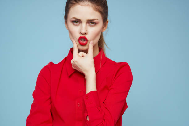 istock attractive woman in bright clothes on blue background gesturing with hands and red lips makeup cropped view emotions 2104927040