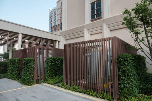 private suburban house with backyard behind high fence. beautiful landscape recreation cottage complex in ecological area with green thuja hedge. Modern architecture, riches and luxury concept.