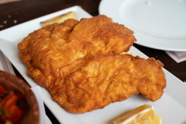 Chicken schnitzel, a thin slice of meat, which usually thinned by pounding with a meat tenderizer. Most commonly, the meat is breaded before frying