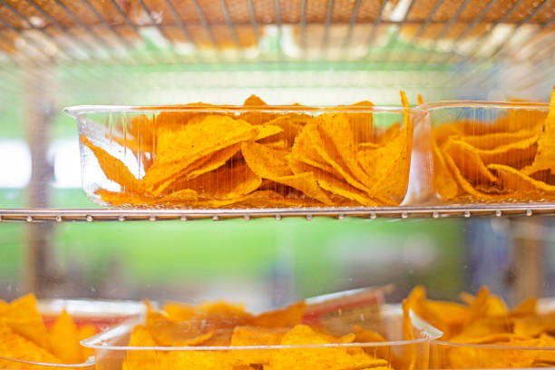 istock potato chips with different flavors in plastic containers. cinephile 2104971467