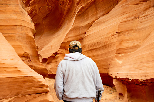 Antelope Canyon, Page Arizona - Antelope Canyon, Page Arizona - a lone hiker in a slot canyon