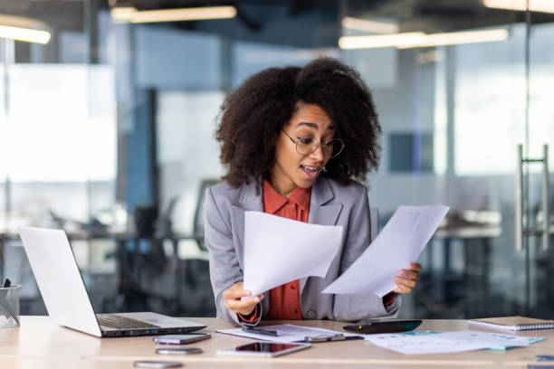 istock Confident businesswoman working with documents in office 2104987508
