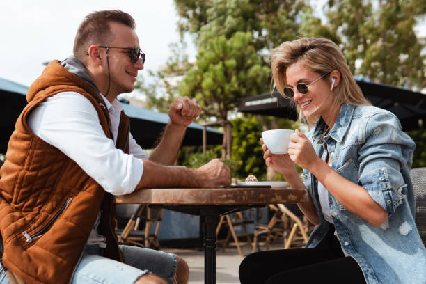 istock Joyful couple engaged in conversation over coffee at an outdoor cafe 2105018600