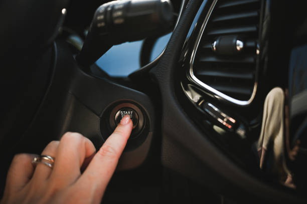 istock Close up of  finger pressing the start/stop engine button in car. 2105030023