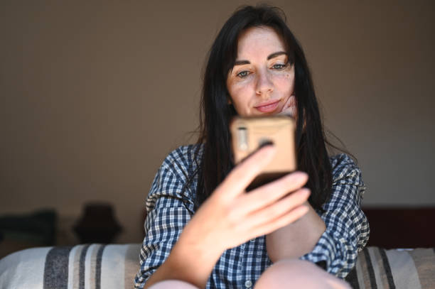 istock Mid adult woman using mobile phone. 2105032099