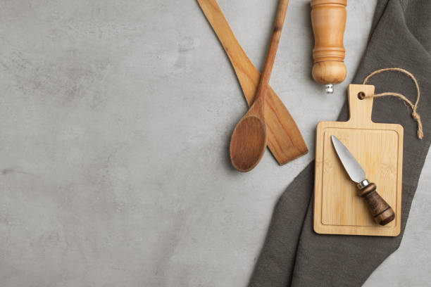 istock Various wooden and bamboo kitchen utensils are laid out on a pastel background. top view. flat lay 2105043576