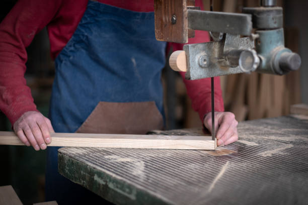 istock unknown male carpenter is working wood in workshop 2105044649