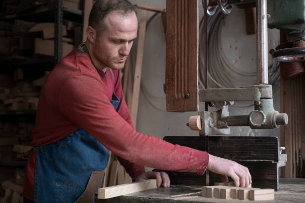 istock carpenter working on a piece of wood in the workshop 2105045175