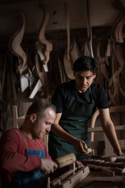 istock The carpenter master and his assistant are processing wood in the workshop 2105047297