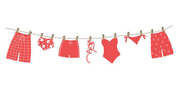 illustrazioni stock, clip art, cartoni animati e icone di tendenza di red swimsuits and swimming trunks hanging on a clothesline - swimming trunks bikini swimwear red