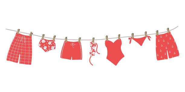 red swimsuits and swimming trunks hanging on a clothesline - swimming trunks bikini swimwear red stock illustrations
