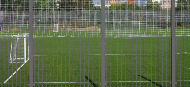 football field near fence at day sunny day stock photo