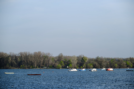 Boats standing anchored on the riverbank of the river Danube in Zemun, a suburb of Belgrade, Serbia during a spring sunny day. Peace and tranquility.