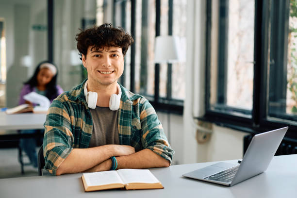 istock Happy university student in the classroom looking at camera. 2105089393
