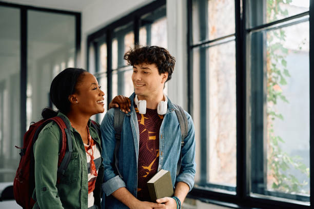 istock Happy university friends talking in the classroom. 2105097927