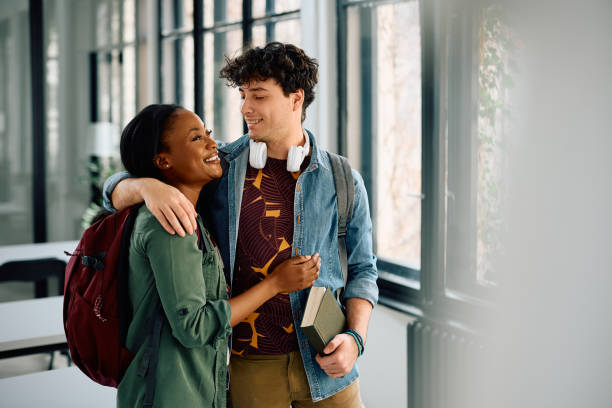 istock Happy university couple embracing in the classroom. 2105098466