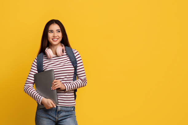 istock Happy young asian lady student holding laptop 2105099047