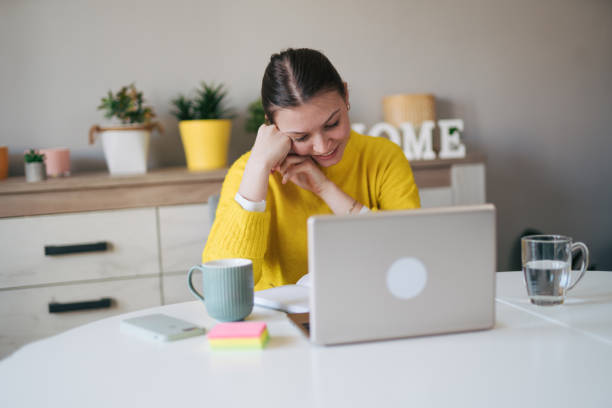 istock Young woman working from her home office. 2105100630