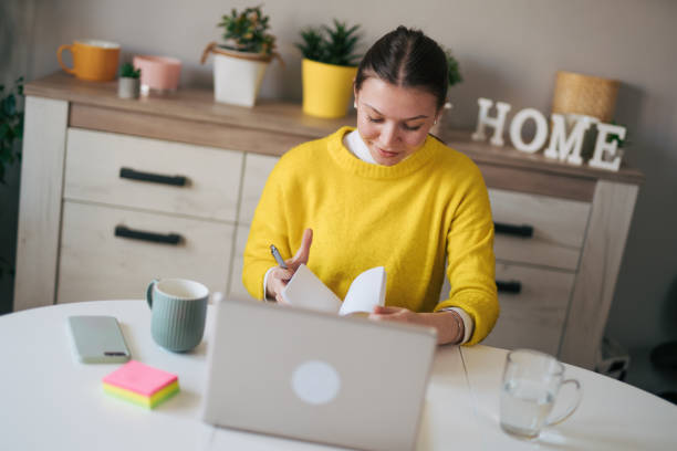 istock Young woman working from her home office. 2105112698