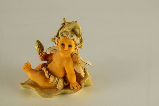 Close-up of child angel statuette Object on a White Background
