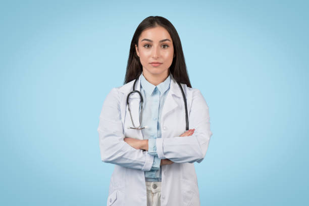 istock Confident female doctor with stethoscope on blue background 2105142896