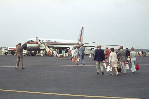 Berlin (West), Germany, 1970. Boarding. Passengers walk across the airfield and board a plane at the former Tegel airfield.