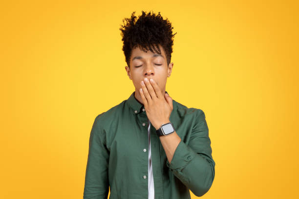 istock Sleepy young black guy yawning with closed eyes 2105198270