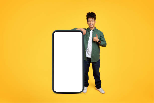 istock Smiling handsome young black man with huge smartphone 2105198815