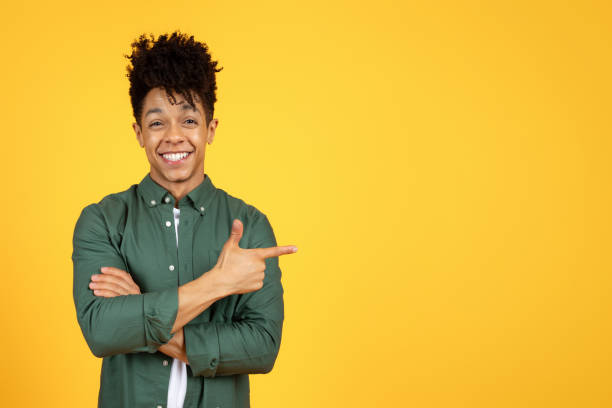 istock Cool african american guy showing blank copy space 2105198868