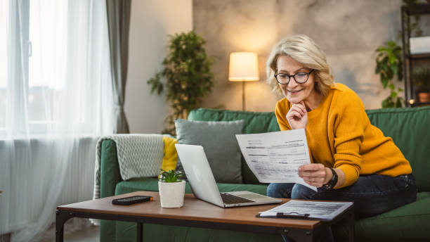 istock mature caucasian woman use laptop computer at home for work on project 2105203108