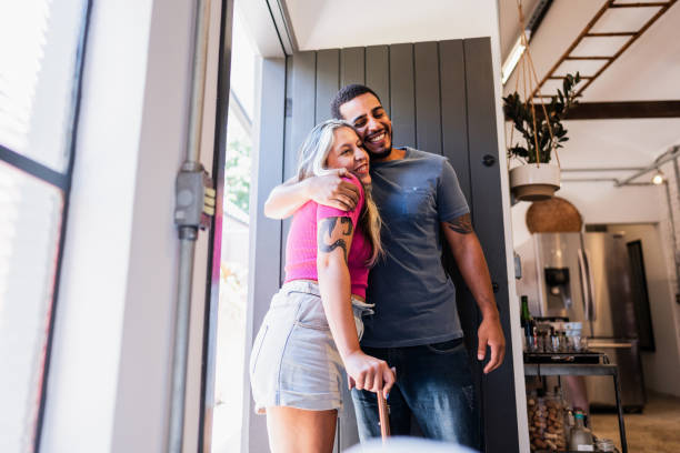 istock Young man greeting a friend at home 2105218372