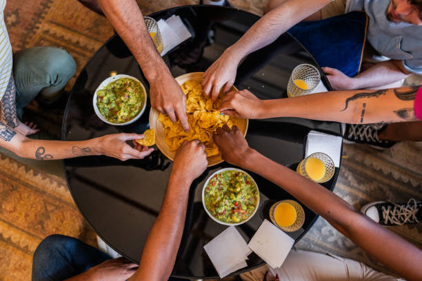 istock Friends eating guacamole with nacho at home 2105227891