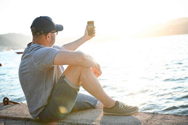 istock Mature adult man traveler ( with mobile phone) 2105250082