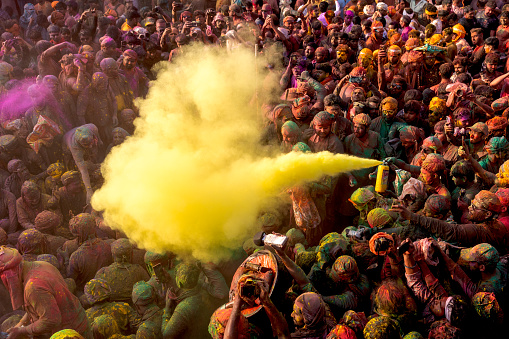 MATHURA, UTTAR PRADESH, INDIA - 2024/03/19:  Holi Celebration at Nandgaon Temple. People are celebrating Holi Colour Powder during Holi Festival. 
Holi also known as the Festival of Colours, Festival of Spring, and Festival of Love, is one of the most popular and significant festivals in Hinduism.  It celebrates the eternal and divine love of god Radha and Krishna. The day also signifies the triumph of good over evil as it commemorates the victory of god Vishnu as Narasimha Narayana over Hiranyakashipu.
Mathura, Vrindavan is the place where lord Krishna has born.

Note: This Temple is neither a privet property nor there is photography restricted. Do not need any ticket to enter this temple. This is a Hindu god lord Krishna's temple and this is public property which is maintained by temple authority.