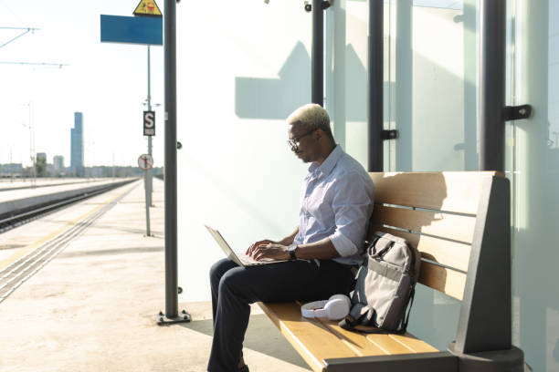 istock African American businessman using laptop on the train station 2105302726