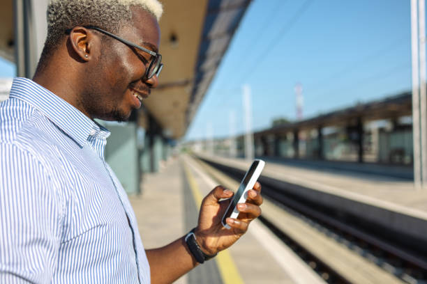 istock African American handsome man using smart phone on the train station 2105304874
