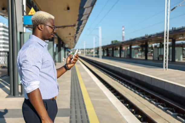 istock African American handsome man using smart phone on the train station 2105304875