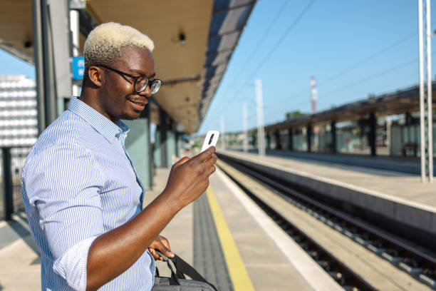 istock African American handsome man using smart phone on the train station 2105304876