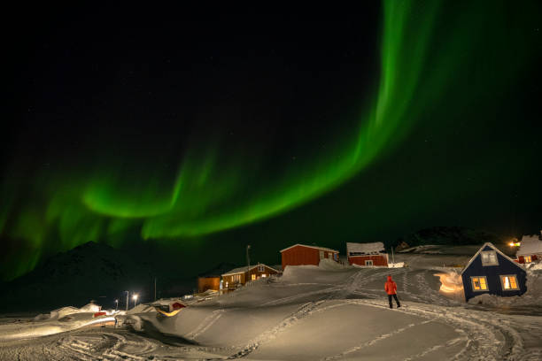 Skier explores village at night