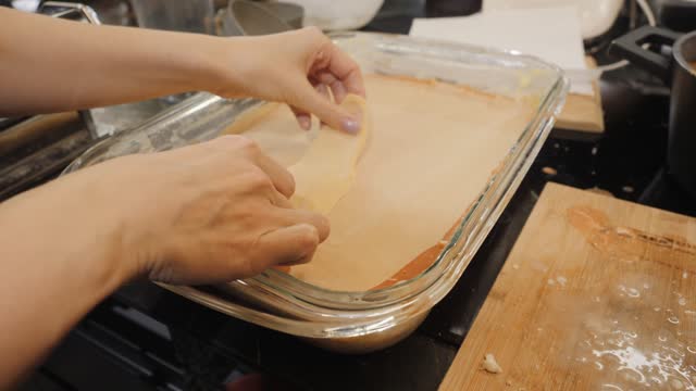 The chef prepares Italian lasagna