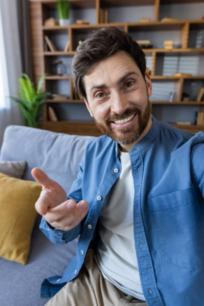 istock Casual man gesturing during a conversation at home 2105374538