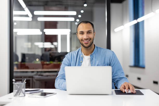 istock Confident businessman working late in a modern office 2105378314