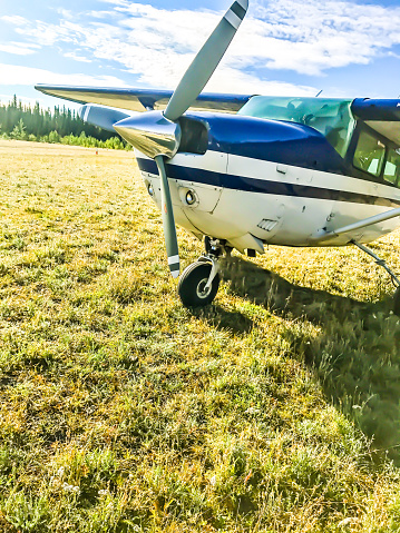 A small plane sits alongside a rural airport in Alaska