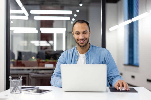 istock Professional man working on laptop in modern office 2105396411